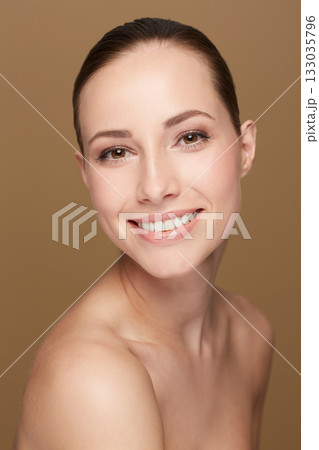 Portrait, smile and woman with dermatology, cosmetics and beauty against a brown studio background. Face, female person and model with skincare, salon treatment and luxury with wellness and self care Portrait, smile and woman with dermatology, cosmetics and beauty against a brown studio background. Face, female person and model with skincare, salon treatment and luxury with wellness and self care 133035796