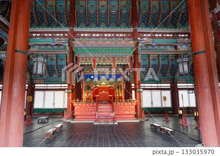 Intricately Painted Wooden Pillars and Vibrant Dancheong Ceilings in the Historic Interior of a Traditional Korean Palace 133035970