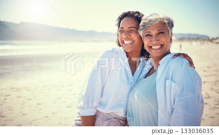 Mother with her adult daughter at the beach while on a vacation, weekend trip or summer getaway. Happy, smile and woman embracing her senior mom by the ocean while on a tropical holiday or adventure. Mother with her adult daughter at the beach while on a vacation, weekend trip or summer getaway. Happy, smile and woman embracing her senior mom by the ocean while on a tropical holiday or adventure. 133036035