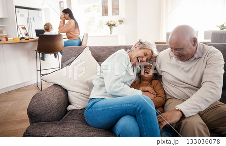 Laughing, happy and grandparents babysitting a child, bonding and being funny on the sofa. Smile, comic and boy kid speaking to a senior man and woman on the living room couch for quality time 133036078