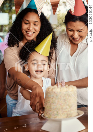 Birthday, party and cake for girl with mother and grandmother together for celebrating, bond and fun. Candle, event and child with parents and grandparent at table, happy and excited for celebration 133036144