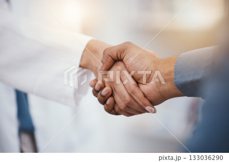 Doctor, patient and handshake in hospital thank you, welcome or greeting for medicine trust, help or medical consulting. Zoom, black man and shaking hands with pharmacy worker or healthcare employee 133036290