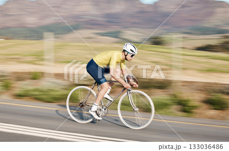 Cycling, fitness and man with bicycle on road, speed and action, motion blur of cyclist outdoor and helmet for safety. Mockup space, athlete and training for race, exercise in countryside with bike Cycling, fitness and man with bicycle on road, speed and action, motion blur of cyclist outdoor and helmet for safety. Mockup space, athlete and training for race, exercise in countryside with bike 133036486