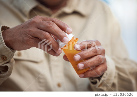 Medication, healthcare and male hands with pills for recovery, wellness and health in his home. Medicine, medical emergency and mature man taking tablets for a flu, cold or sickness in his house. 133036526