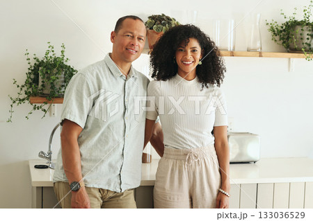 Happy, love and portrait of a couple in the kitchen of their new modern home together in Mexico. Happiness, smile and mature married man and woman bonding and embracing while standing in their house. 133036529