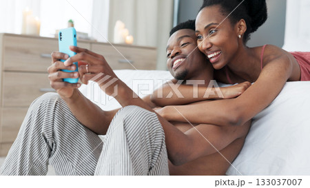 Social media, smile or couple take a selfie in bedroom together on a network app online in the morning. Photograph, memory or happy black woman taking fun pictures with African man or partner to post Social media, smile or couple take a selfie in bedroom together on a network app online in the morning. Photograph, memory or happy black woman taking fun pictures with African man or partner to post 133037007