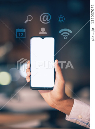 Hands, phone and mockup screen with icons at night for networking, social media or communication at the office. Hand of employee showing smartphone display for mobile app, branding or multimedia 133037072