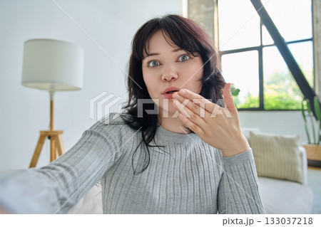 Selfie portrait happy beautiful young woman in home interior 133037218