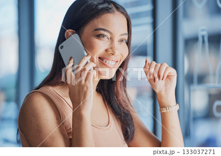 Phone, call and woman talking or calling for a mobile conversation, discussion and chatting feeling happy and smile. Girl, networking and excited female by a window speaking on a smartphone 133037271
