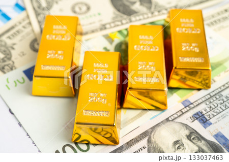 Gold bars on US dollar banknote money, finance trading investment business currency. 133037463