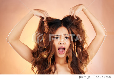 Hair care, portrait and woman stress, frizz and messy style against a brown studio background. Face, female and girl with scalp treatment, volume and hair loss with shock, facial expressions or issue Hair care, portrait and woman stress, frizz and messy style against a brown studio background. Face, female and girl with scalp treatment, volume and hair loss with shock, facial expressions or issue 133037600