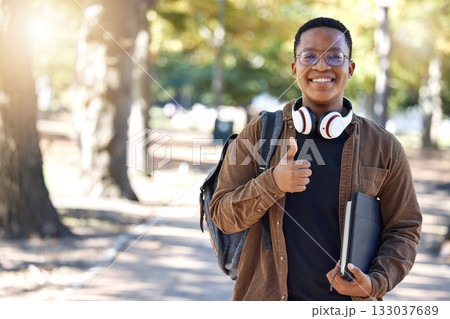 Black man, portrait or thumbs up on campus, park nature or garden in college review, university like or school vote. Smile, happy or student with thumb hands for learning success or education growth 133037689