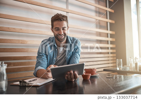 Smile, internet and a man with a tablet at a cafe for communication, connectivity and administration. Happy, remote work and a male entrepreneur reading from the web with technology at a coffee shop 133037714