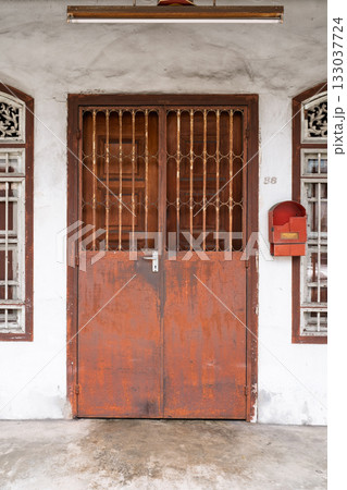 Rusty metal shophouse door with vintage details in George Town, Penang, Malaysia 133037724