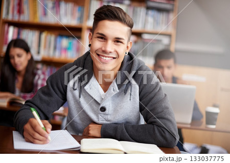 Learning, writing and college with portrait of man in library for education, research and classroom quiz. Focus, study and notebook with student at university for knowledge, scholarship and project 133037775