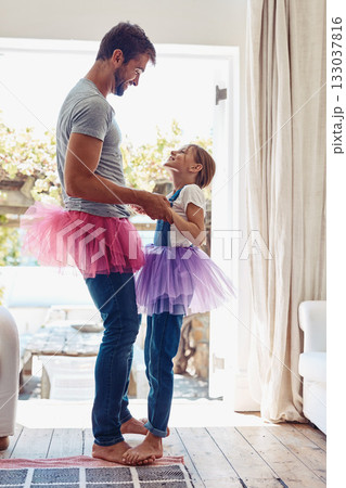 Young girl on man feet, ballet dancing and fun with learning at home in tutu, bond with love and creativity. Family, father and daughter dance in living room, ballerina lesson and time together Young girl on man feet, ballet dancing and fun with learning at home in tutu, bond with love and creativity. Family, father and daughter dance in living room, ballerina lesson and time together 133037816