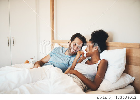 Interracial couple, laughing and relax on bed for morning bonding, funny relationship or joke at home. Happy woman and man with smile, laugh and lying in bedroom for fun talk or conversation indoors Interracial couple, laughing and relax on bed for morning bonding, funny relationship or joke at home. Happy woman and man with smile, laugh and lying in bedroom for fun talk or conversation indoors 133038012
