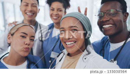Doctors, nurses and teamwork selfie with smile in hospital with diversity, healthcare and social media. Photography, men and women together, happy staff and medical professional friends at clinic. 133038564