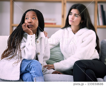 Sad, friends and worry with women on sofa in living room for comfort, grief and depression. Mental health, emotional support and care with girl consoling at home for solidarity, advice and sympathy 133038686