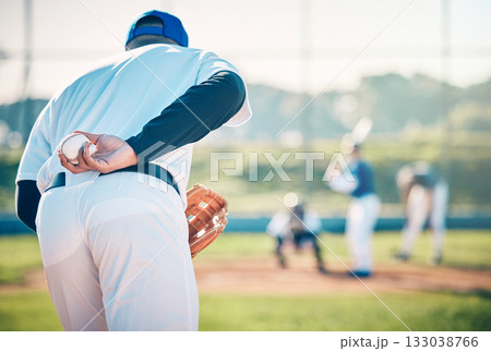 Man, baseball and pitcher ready to throw ball for game, match or victory shot on grass field at pitch. Male sports player with hand behind back with mitt in preparation for sport pitching outdoors 133038766
