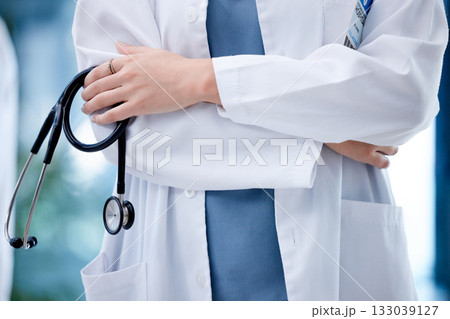 Doctor, hands and arms crossed with stethoscope in healthcare for leadership, management or life insurance. Hands of confident medical professional or expert in cardiology ready for health checkup Doctor, hands and arms crossed with stethoscope in healthcare for leadership, management or life insurance. Hands of confident medical professional or expert in cardiology ready for health checkup 133039127