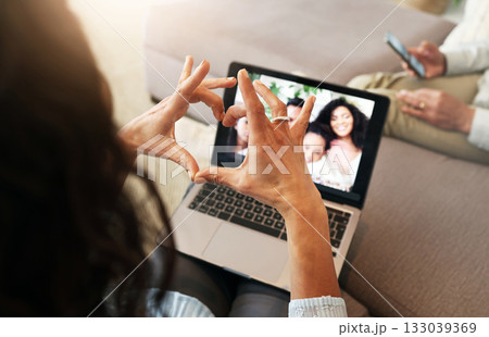 Hand heart, video call and love with laptop screen, family and communication with emoji, connection and bonding. Hands, relax at home and happy with care, connectivity and virtual chat in lounge Hand heart, video call and love with laptop screen, family and communication with emoji, connection and bonding. Hands, relax at home and happy with care, connectivity and virtual chat in lounge 133039369