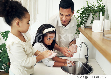 Dad, kids and washing hands in bathroom with soap at tap teaching girls hygiene on morning routine. Water, soap and man with children cleaning dirt, bacteria and germs for health, care and wellness. Dad, kids and washing hands in bathroom with soap at tap teaching girls hygiene on morning routine. Water, soap and man with children cleaning dirt, bacteria and germs for health, care and wellness. 133039376