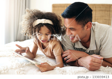 Child learning, tablet and father teaching for online development, home education and relax on bed. Dad or black man with kid on digital app technology for internet game, helping and bonding together Child learning, tablet and father teaching for online development, home education and relax on bed. Dad or black man with kid on digital app technology for internet game, helping and bonding together 133039413