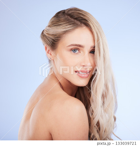 Beauty, hair care and face portrait of woman in studio isolated on a blue background. Cosmetics, keratin and happy young female model with salon treatment for hairstyle, blonde balayage and growth. Beauty, hair care and face portrait of woman in studio isolated on a blue background. Cosmetics, keratin and happy young female model with salon treatment for hairstyle, blonde balayage and growth. 133039721