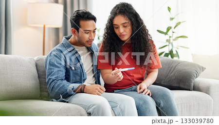 Pregnancy test, home and couple waiting on sofa unsure for fertility doubt, results and parenting news. Relationship, pregnant and man with woman with medical kit for ivf treatment or ovulation 133039780