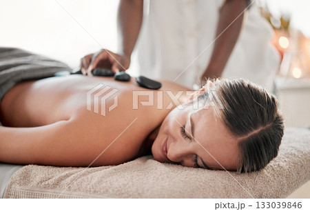 Woman, hot stones or back massage in spa to relax for zen, meditation or wellness physical therapy treatment in resort. Beauty, salon or happy female for luxury healthcare, rock or spiritual peace Woman, hot stones or back massage in spa to relax for zen, meditation or wellness physical therapy treatment in resort. Beauty, salon or happy female for luxury healthcare, rock or spiritual peace 133039846