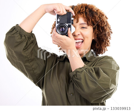 Fun, photo and portrait of a black woman with a camera isolated on a white background in a studio. Excited, professional and photographer filming, shooting and being paparazzi with equipment 133039913