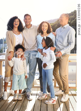 Love, happy and portrait of a big family outdoor on the balcony of their modern house. Happiness, smile and girl children siblings standing with their parents and grandparents outside of the home. Love, happy and portrait of a big family outdoor on the balcony of their modern house. Happiness, smile and girl children siblings standing with their parents and grandparents outside of the home. 133040196