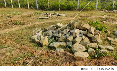 Rock pile in grassy terrain with scattered stones and path Rock pile in grassy terrain with scattered stones and path 133040210