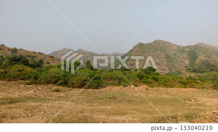Arid hilly area with rocky mountains and dry textured land surface Arid hilly area with rocky mountains and dry textured land surface 133040219