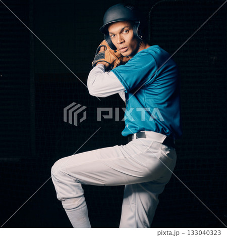 Baseball pitcher, black man and studio portrait with focus, vision and balance for sport, game and motivation. Sports, exercise and training with goals, contest or competition by dark background 133040323