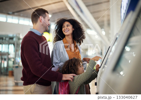 Self service, travel and interracial with family in airport for check in, vacation and global. Technology, digital and smile with parents and child for holiday, flight and ticket information 133040627
