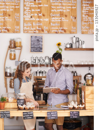 Small business, talking and employees with a tablet, digital planning or share ideas for profit growth. Black man, woman or coworkers with technology, store or happiness with communication at a store 133040927