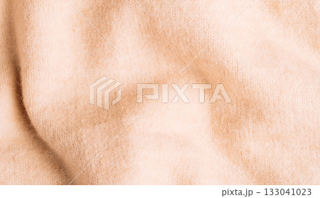 Soft beige woolen fabric with cozy folds background Soft beige woolen fabric with cozy folds background 133041023