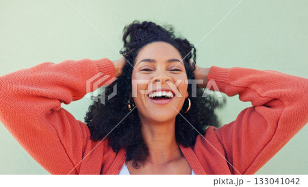 Woman, portrait and happy with hair or play at wall for beauty or energy, curly treatment or wellness. Black person, natural, and smile for cosmetic care or hands in excitement for healthy results Woman, portrait and happy with hair or play at wall for beauty or energy, curly treatment or wellness. Black person, natural, and smile for cosmetic care or hands in excitement for healthy results 133041042