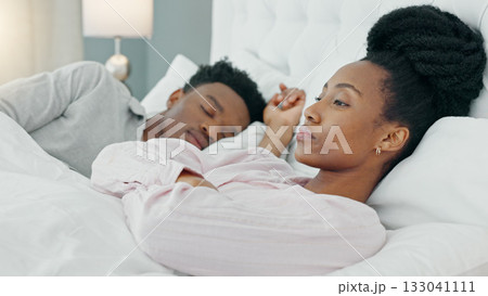 Insomnia, couple and black woman in bed frustrated by snoring, crisis or sleep apnea at home. Sleeping, conflict and angry female with stress, anxiety or divorce depression, liar or bedroom problem 133041111