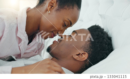 Happy black couple, bed and intimate morning for love, bonding or relax together with smile at home. African man and woman enjoying quality time, conversation or wake up in trust, support or bedroom 133041115