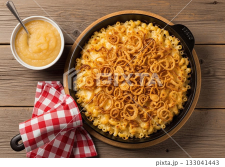 Traditional swiss alpine macaroni with fried onions and applesauce on rustic wooden table Traditional swiss alpine macaroni with fried onions and applesauce on rustic wooden table 133041443