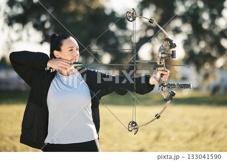 Happy person, bow or arrows aim in sports field, shooting range or gaming nature in hunting, hobby or exercise. Archery, woman or athlete smile with weapon in target training, competition or practice 133041590