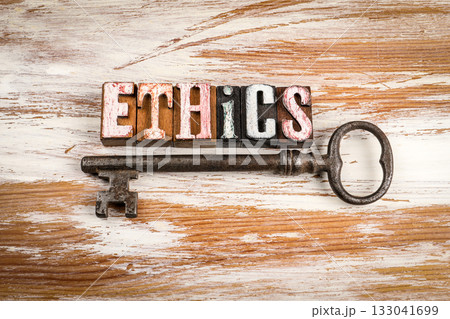 Word ethics made from vintage wooden letterpress blocks with antique metal key on rustic wooden 133041699