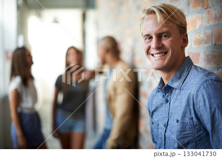 University, education and portrait of man with happy face for study goals, knowledge and learning. College, academy scholarship and male student with friends on campus for studying, class or school 133041730