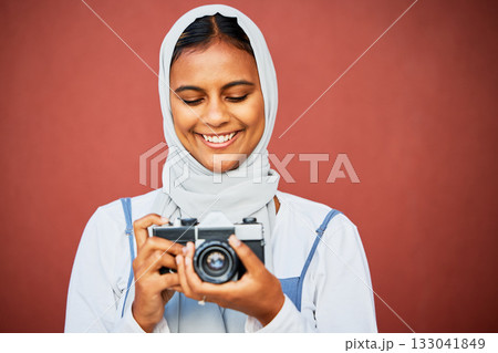 Photography, muslim woman holding camera and mockup, face with smile isolated on red background. Creative professional lifestyle photographer in hijab, hobby or career taking happy photo in studio. 133041849