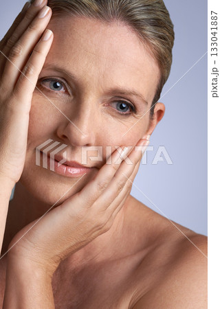 Thinking, beauty and skin with a mature woman in studio on a gray background for antiaging skincare. Idea, face and natural with an attractive elderly female person looking thoughtful about cosmetics 133041887