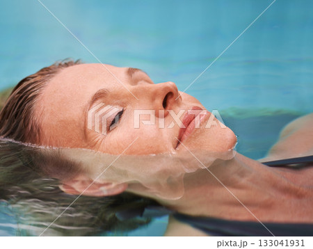 Swimming pool, floating and woman in water relax on holiday, summer vacation and weekend getaway. Travel, luxury resort and closeup of female person relaxing for swim, wellness and peace outdoors Swimming pool, floating and woman in water relax on holiday, summer vacation and weekend getaway. Travel, luxury resort and closeup of female person relaxing for swim, wellness and peace outdoors 133041931