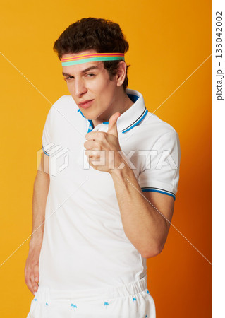 Man, sports portrait and thumbs up isolated on studio background for winning, success and like, vote or yes sign. Face of retro athlete or tennis person okay, good luck and winner hand or funny emoji 133042002